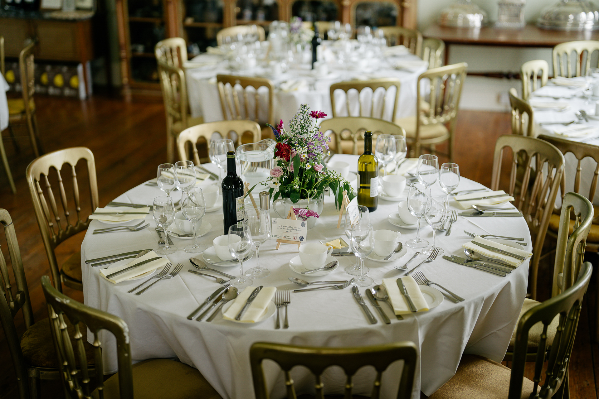 A set dining table with wine glasses and flowers