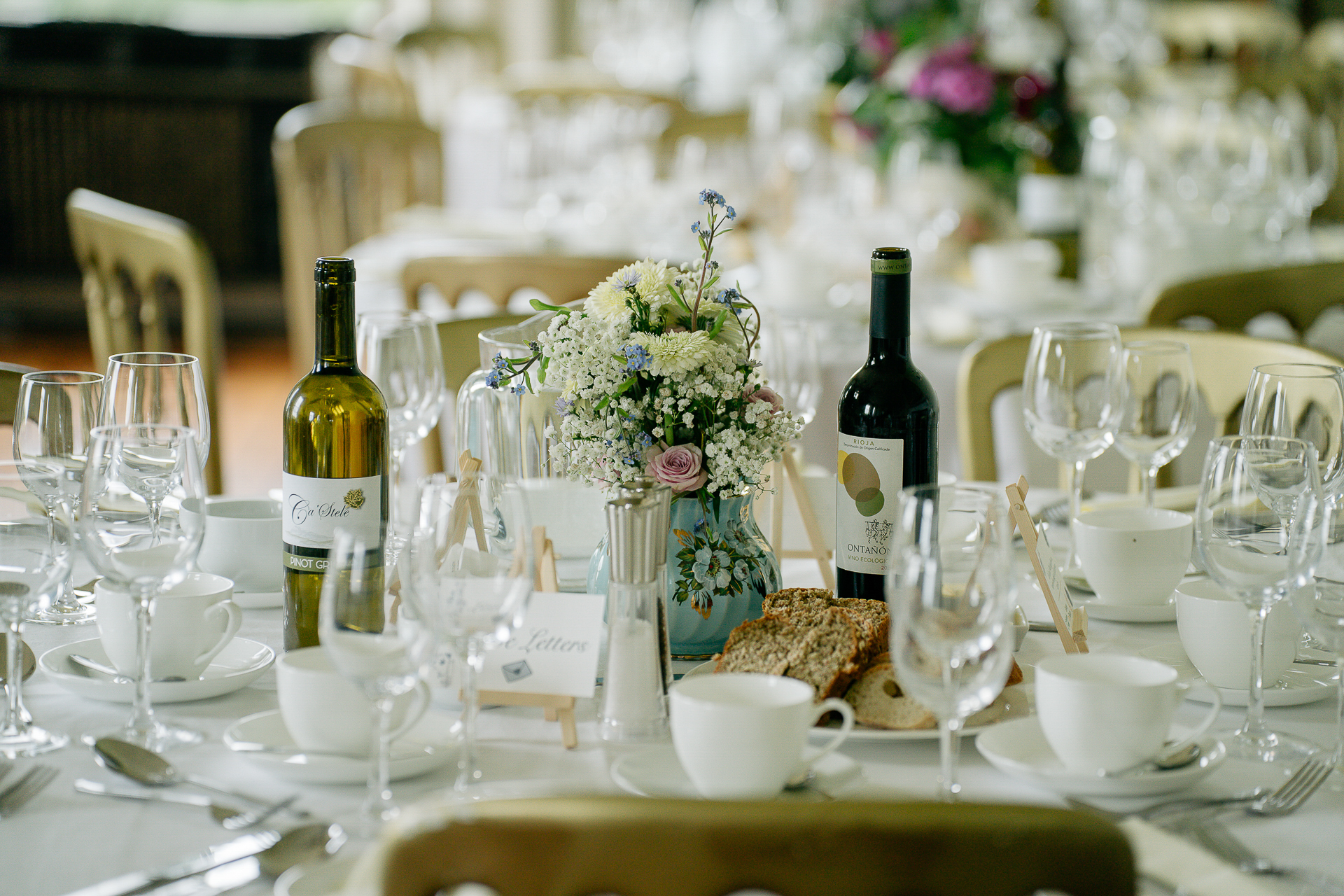 A table with wine glasses and flowers