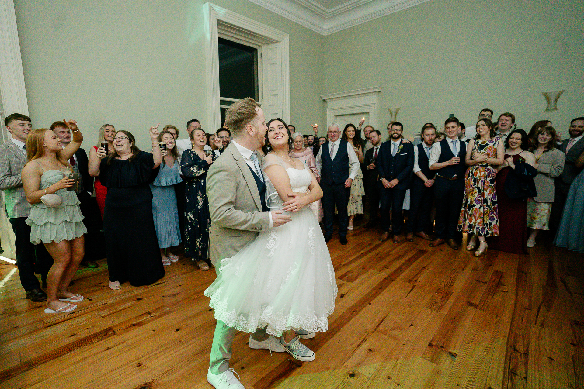 A man and woman dancing in a room full of people