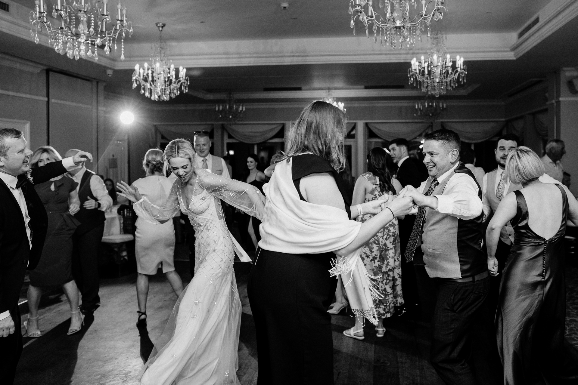 A man and woman dancing in a room full of people