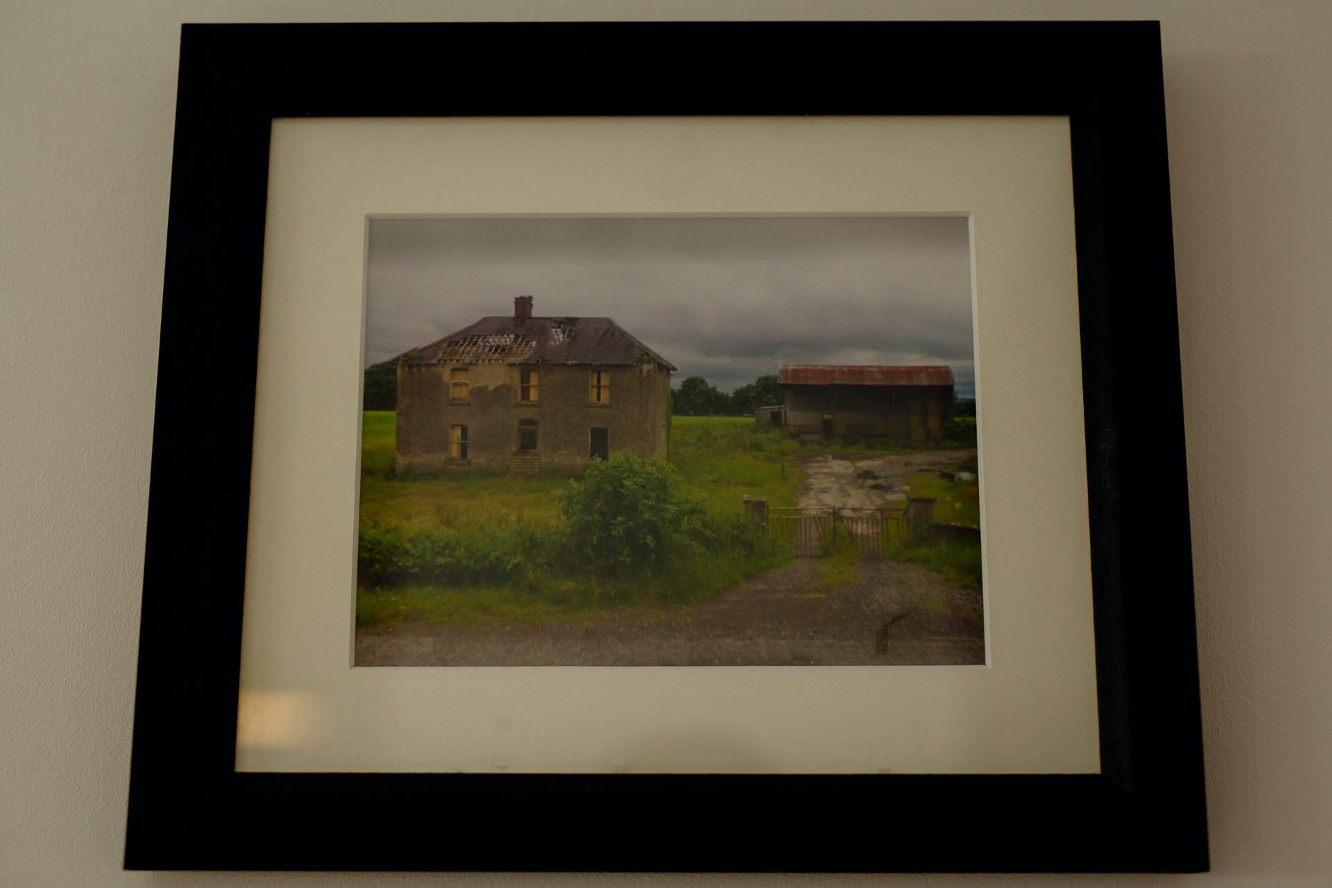 A frame with a house in the background