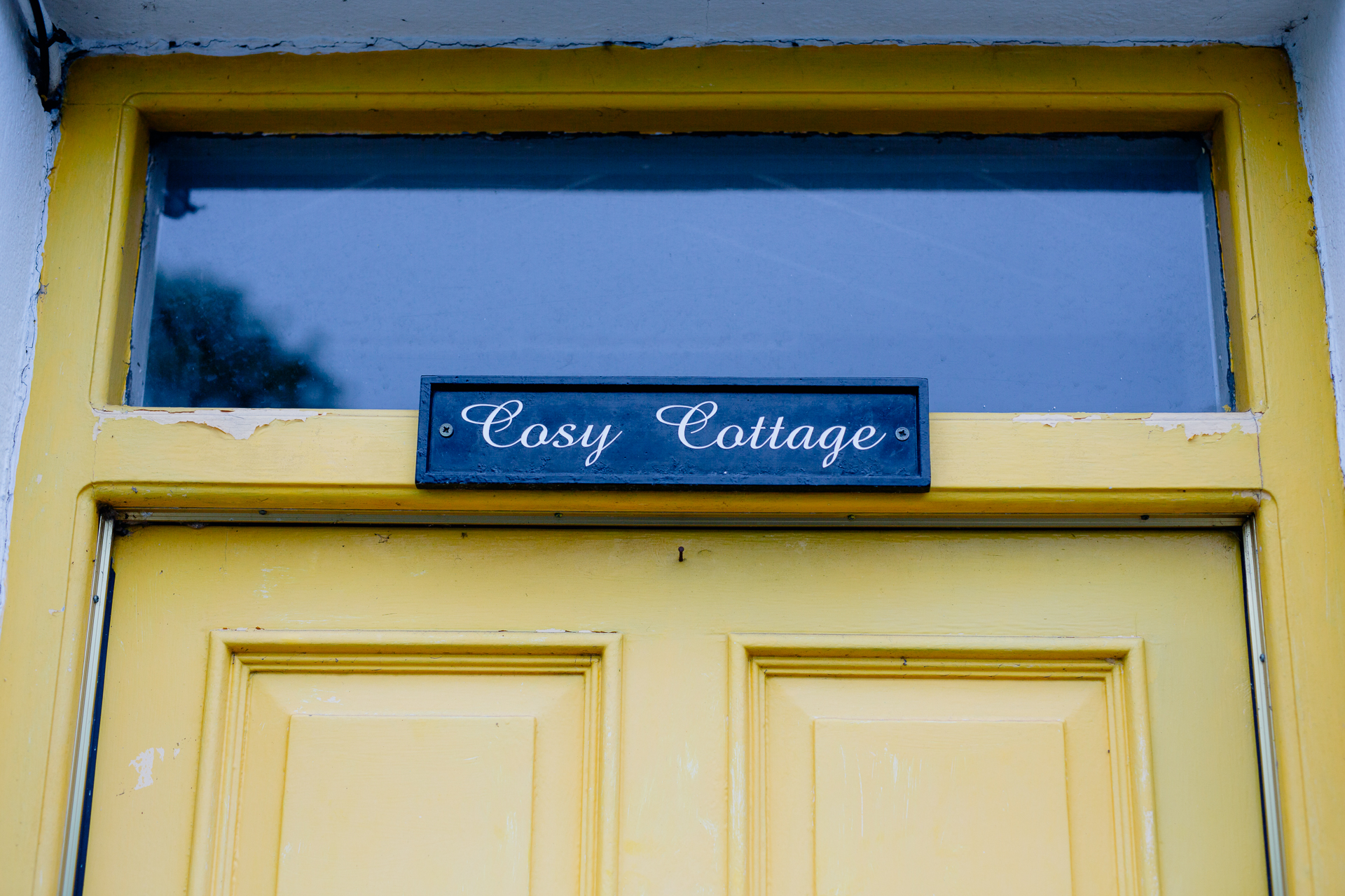 A yellow door with a sign on it