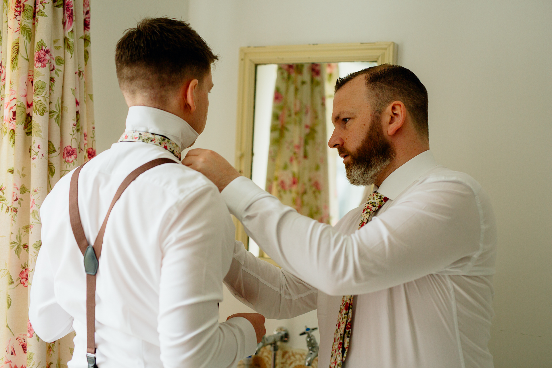 A man getting his tie done