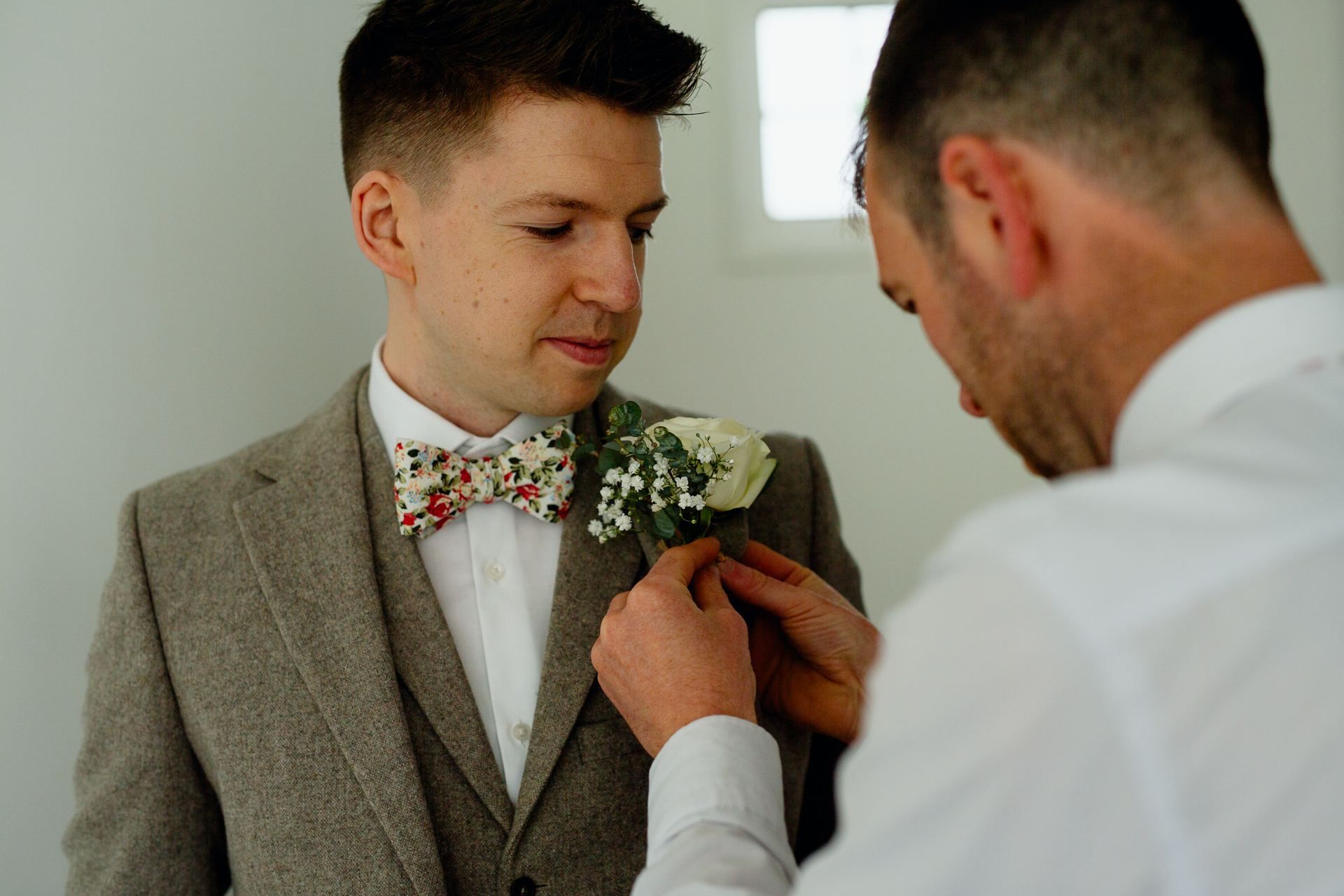 A man in a suit holding a bouquet of flowers