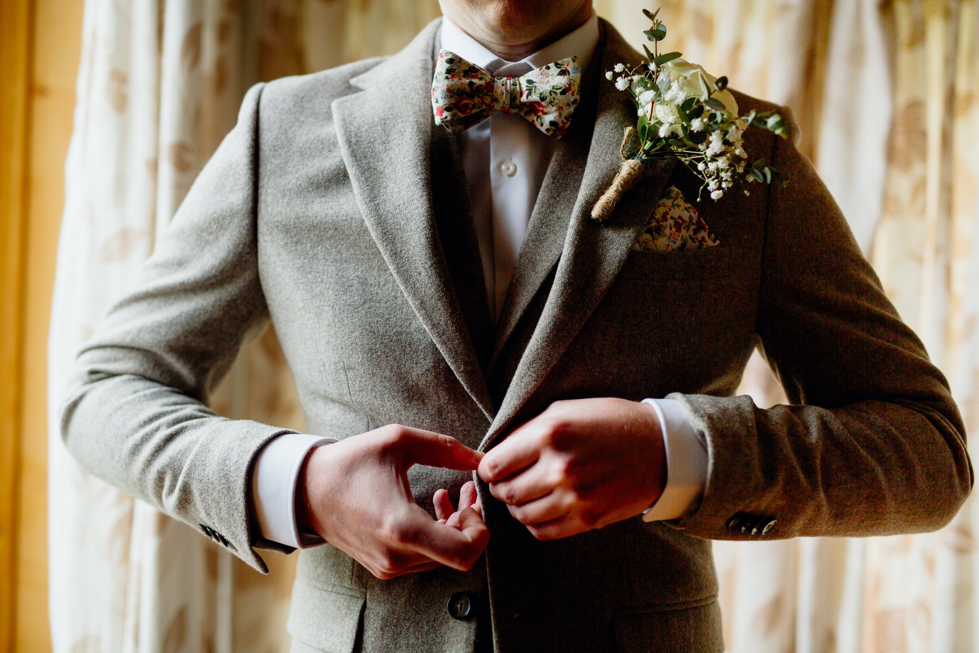 A man in a suit holding a bouquet of flowers