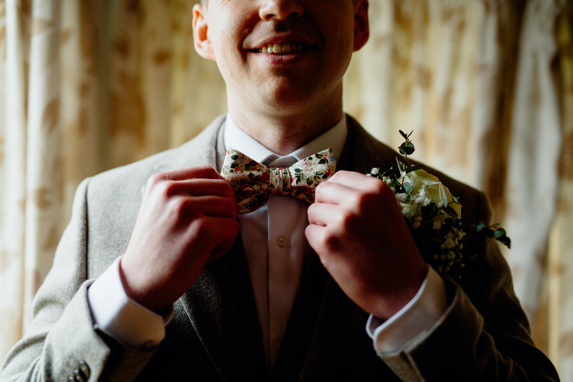 A man wearing a suit and bow tie