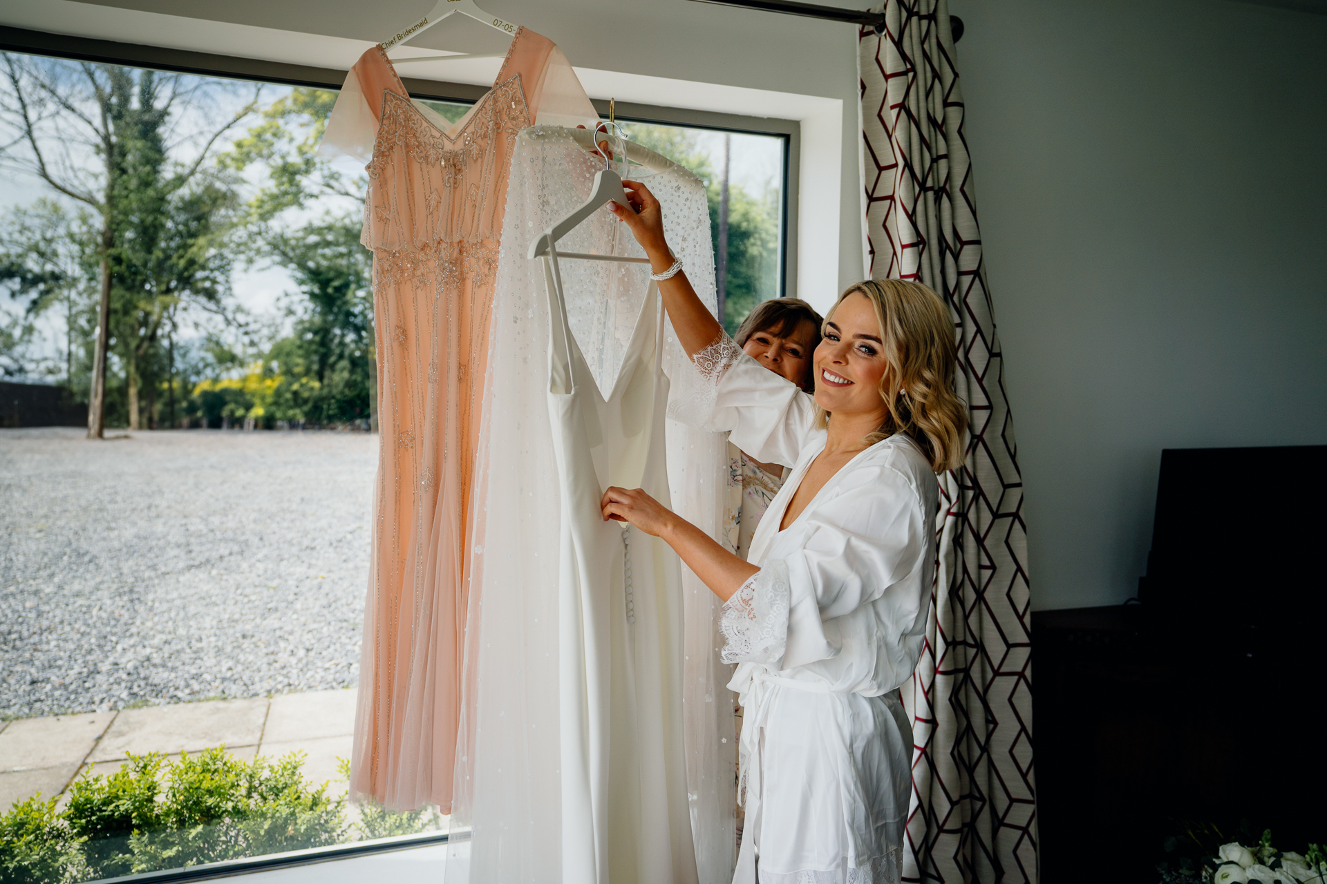 A person in a white dress holding a white cloth over a person in a white dress