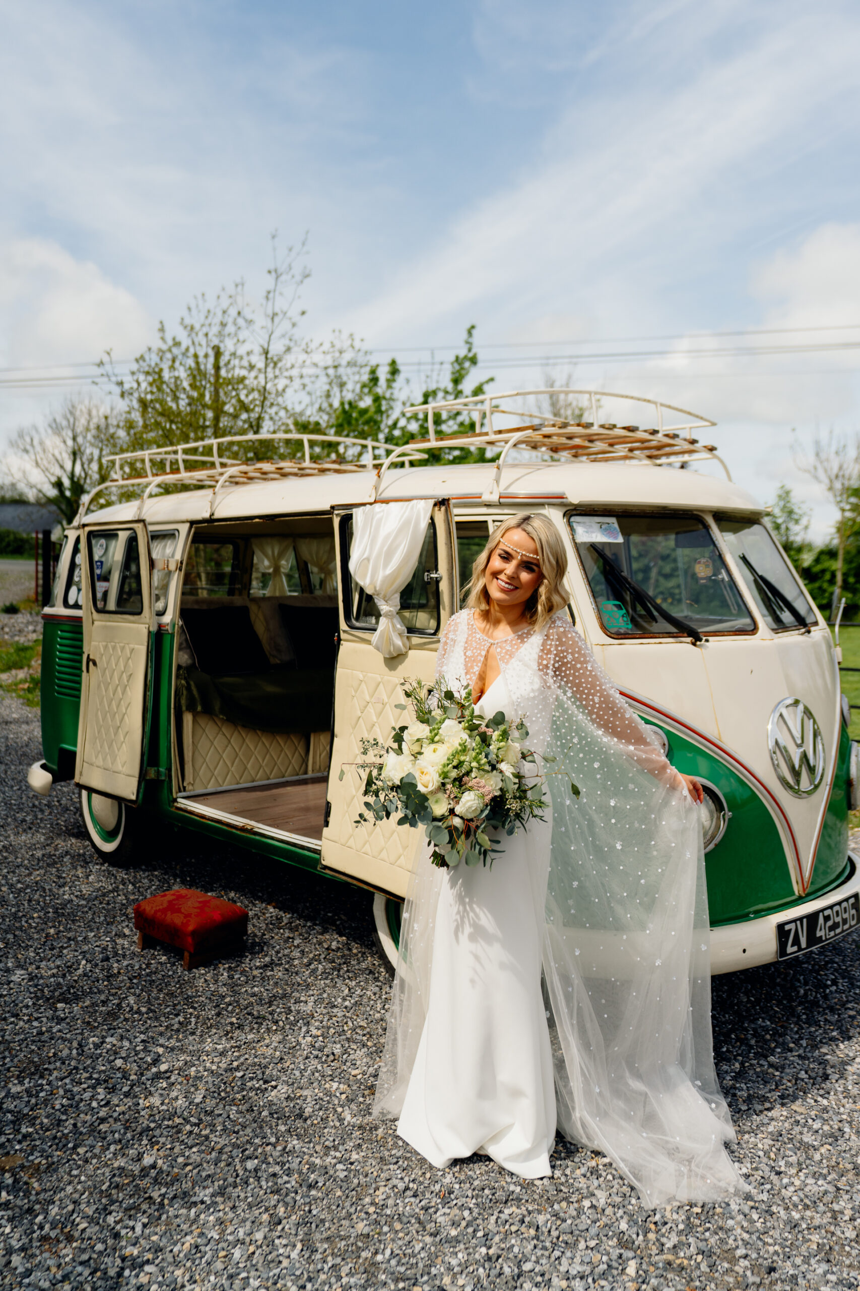 A person in a wedding dress standing in front of a van