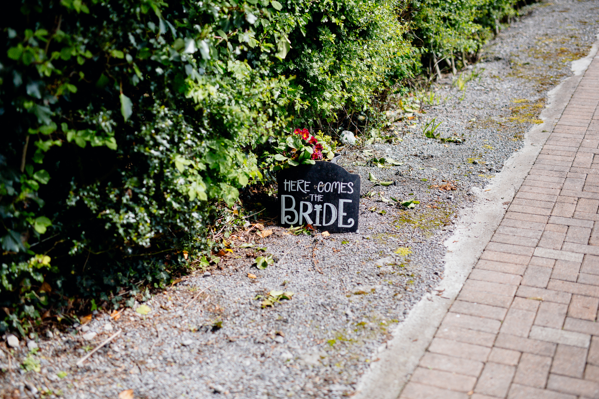 A sign on a brick path