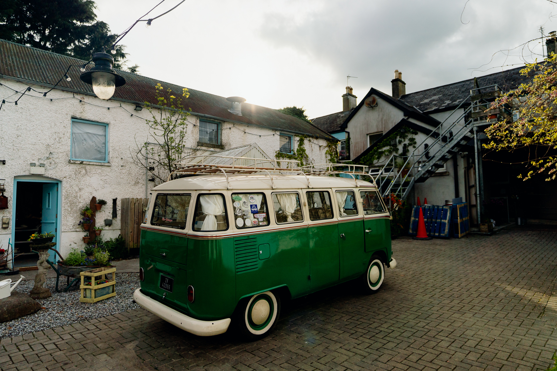 A bus parked on a cobblestone street