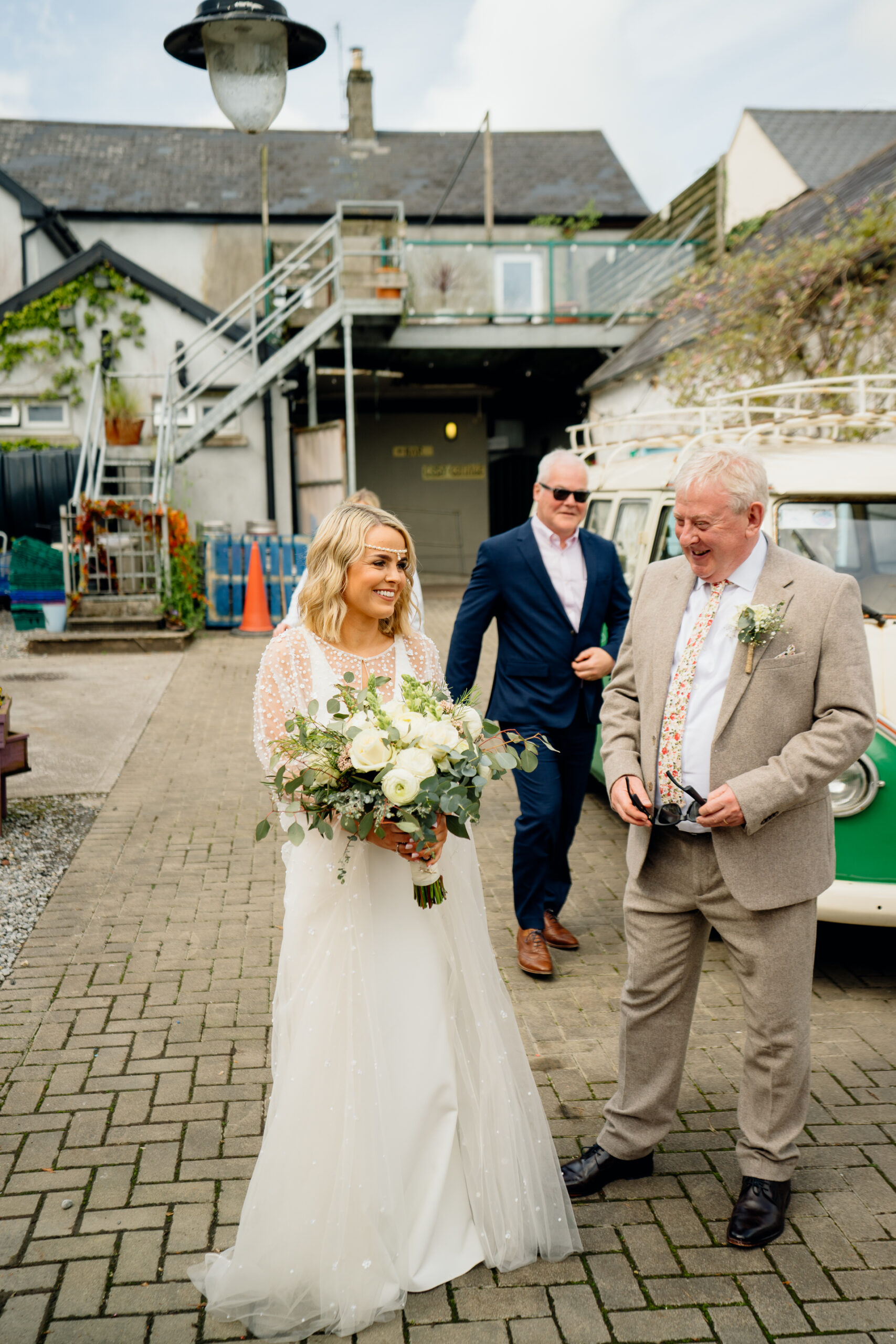 A bride and groom walking down a street