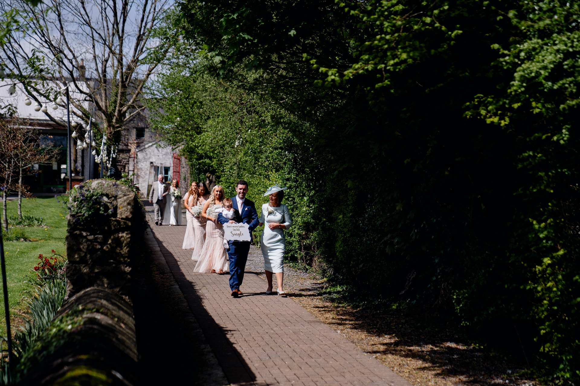 A group of people walking down a sidewalk