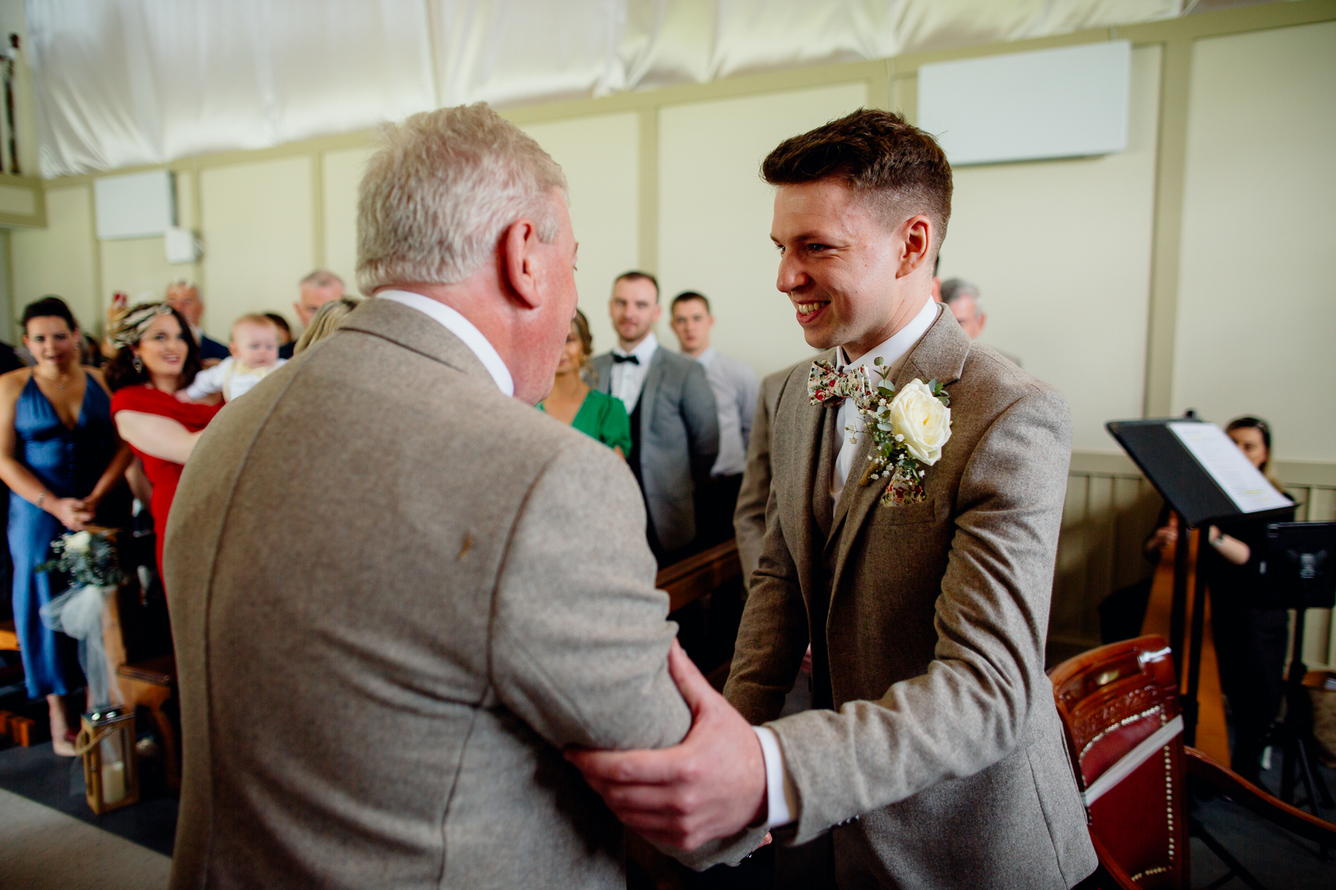 A man in a suit shaking hands with another man in a suit