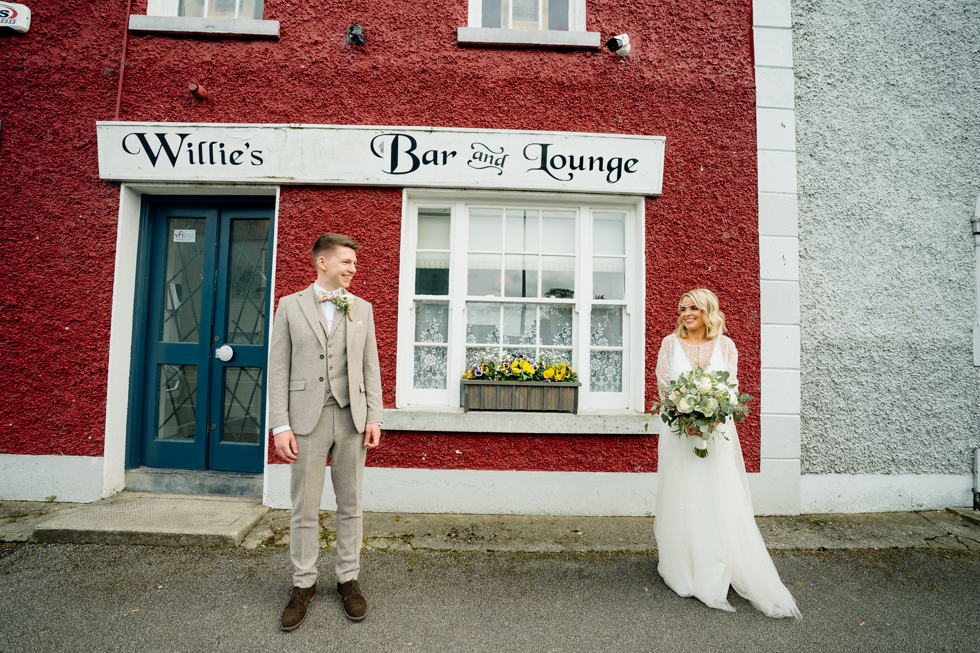 A man and woman in front of a red building