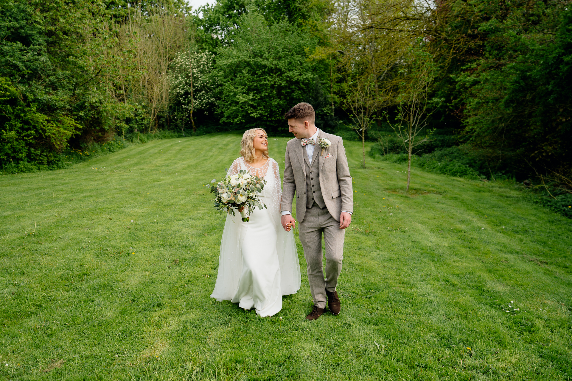 A man and woman walking in a field