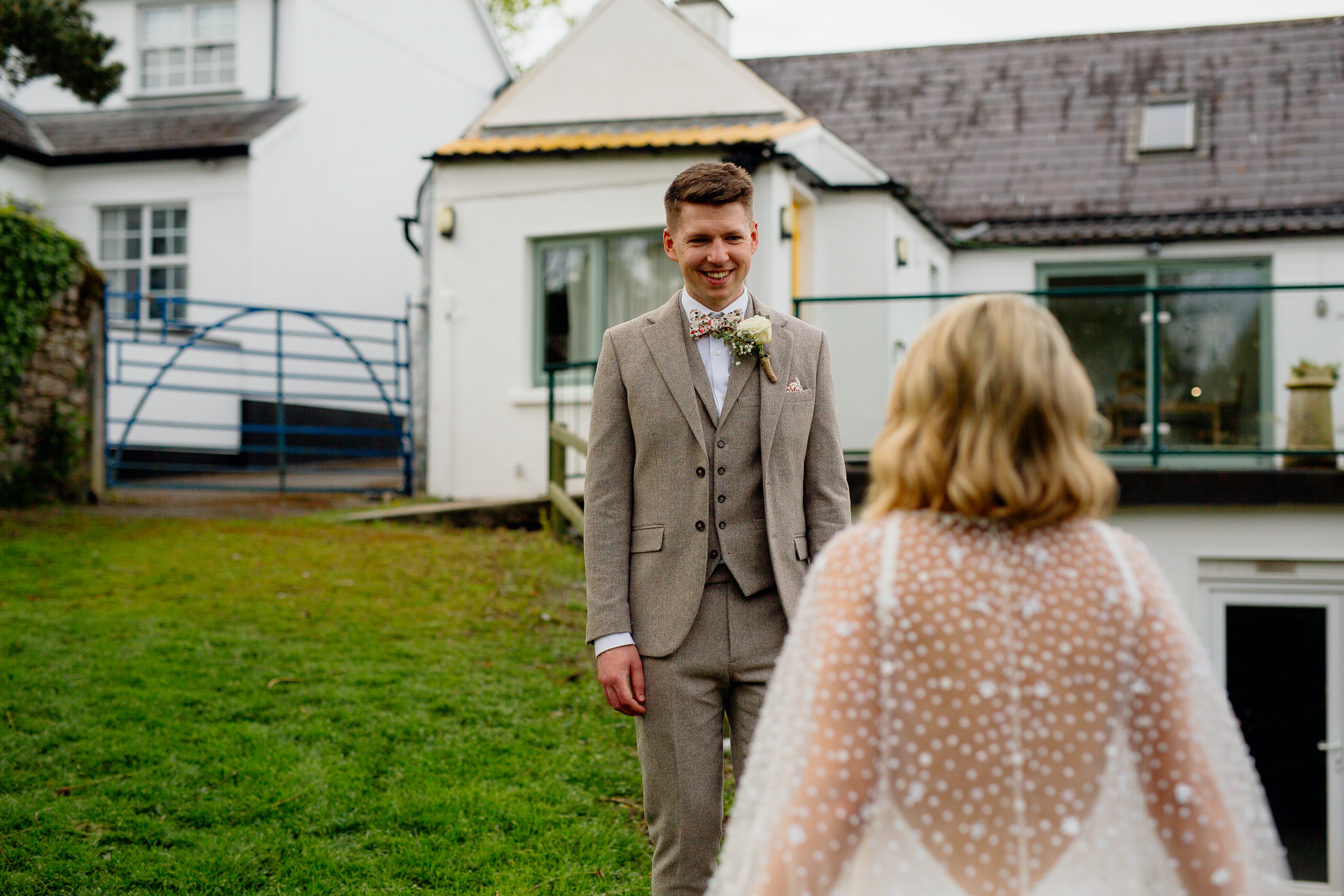 A man in a suit and a woman in a dress walking down a sidewalk