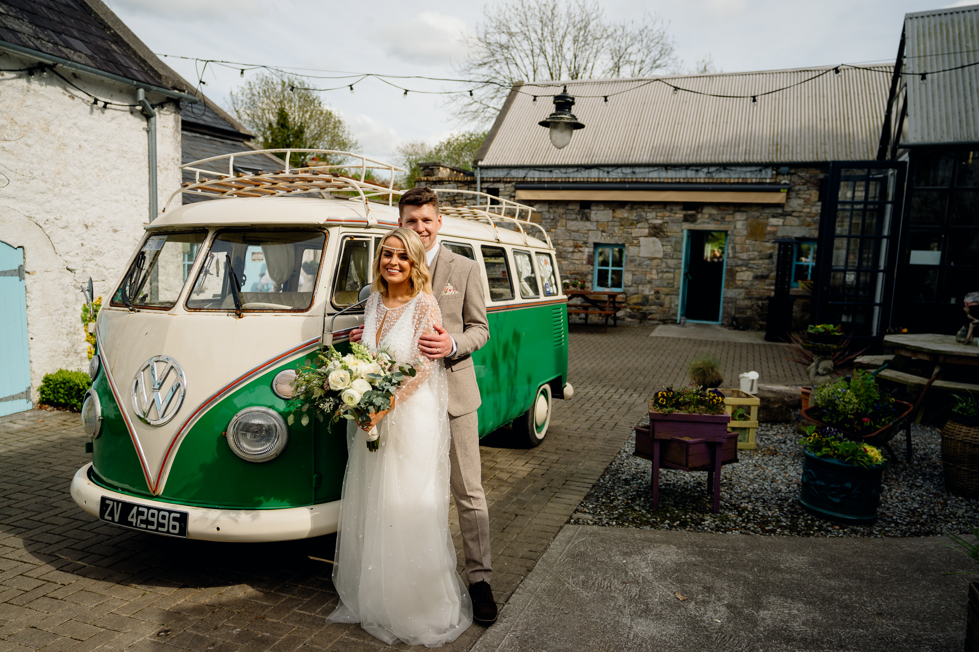 A man and woman posing in front of a van