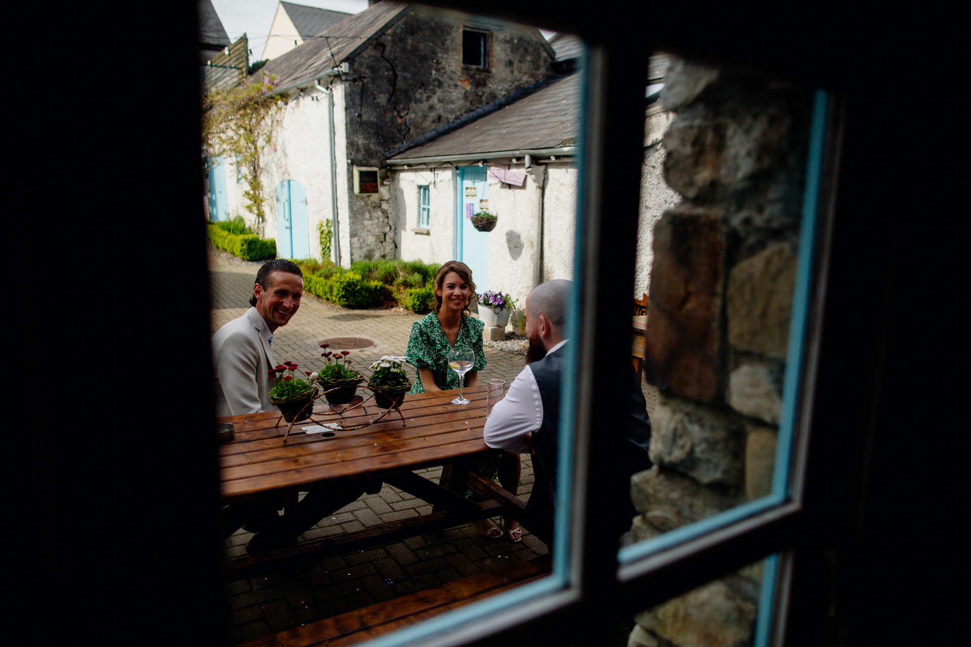 A group of people sitting at a table in a village