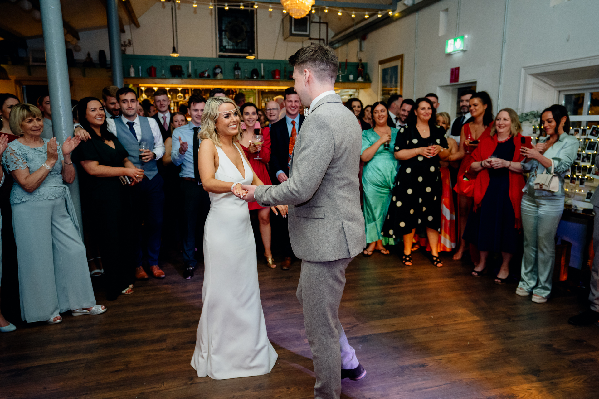 A man and woman dancing in a room full of people