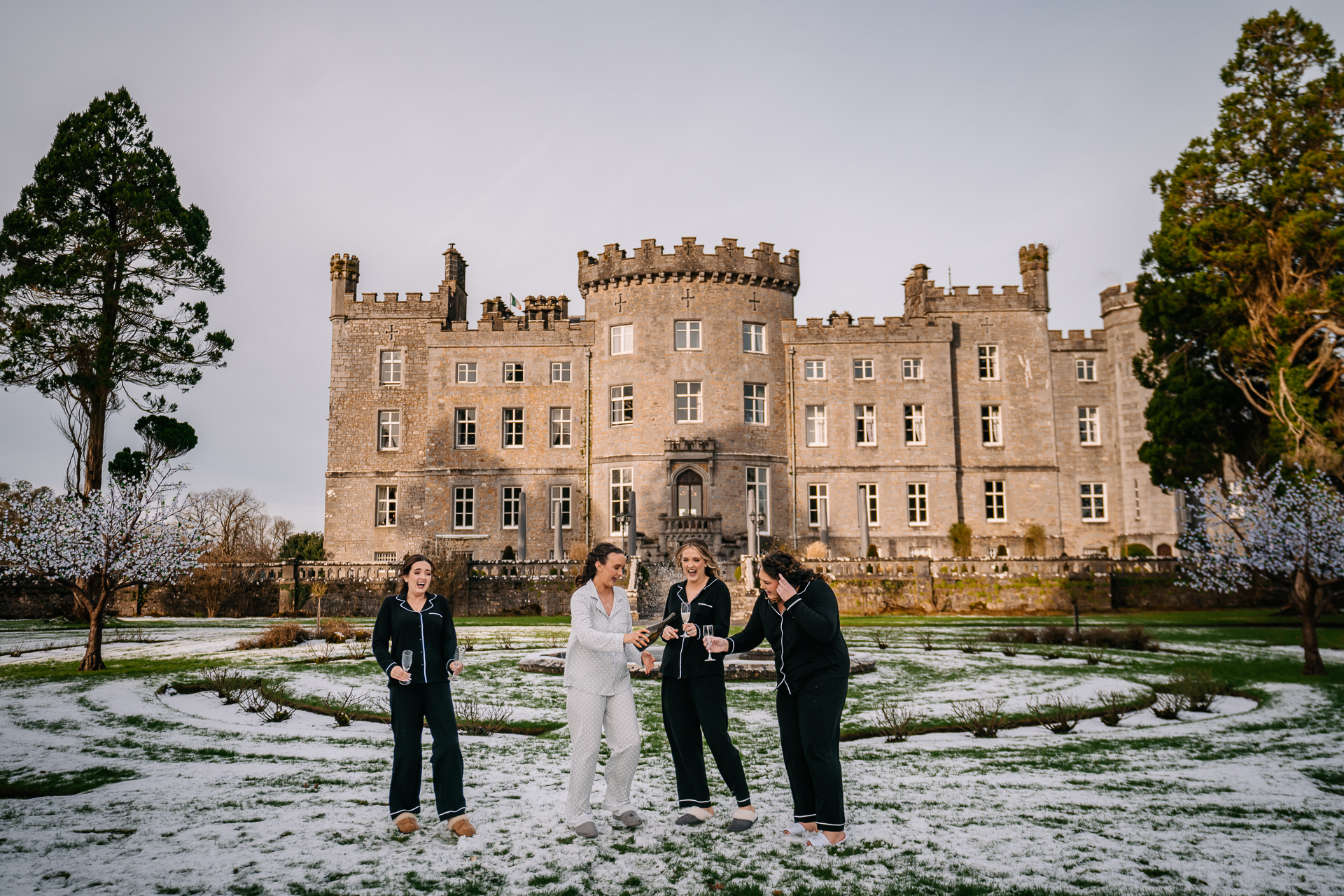 A group of people posing in front of a large building