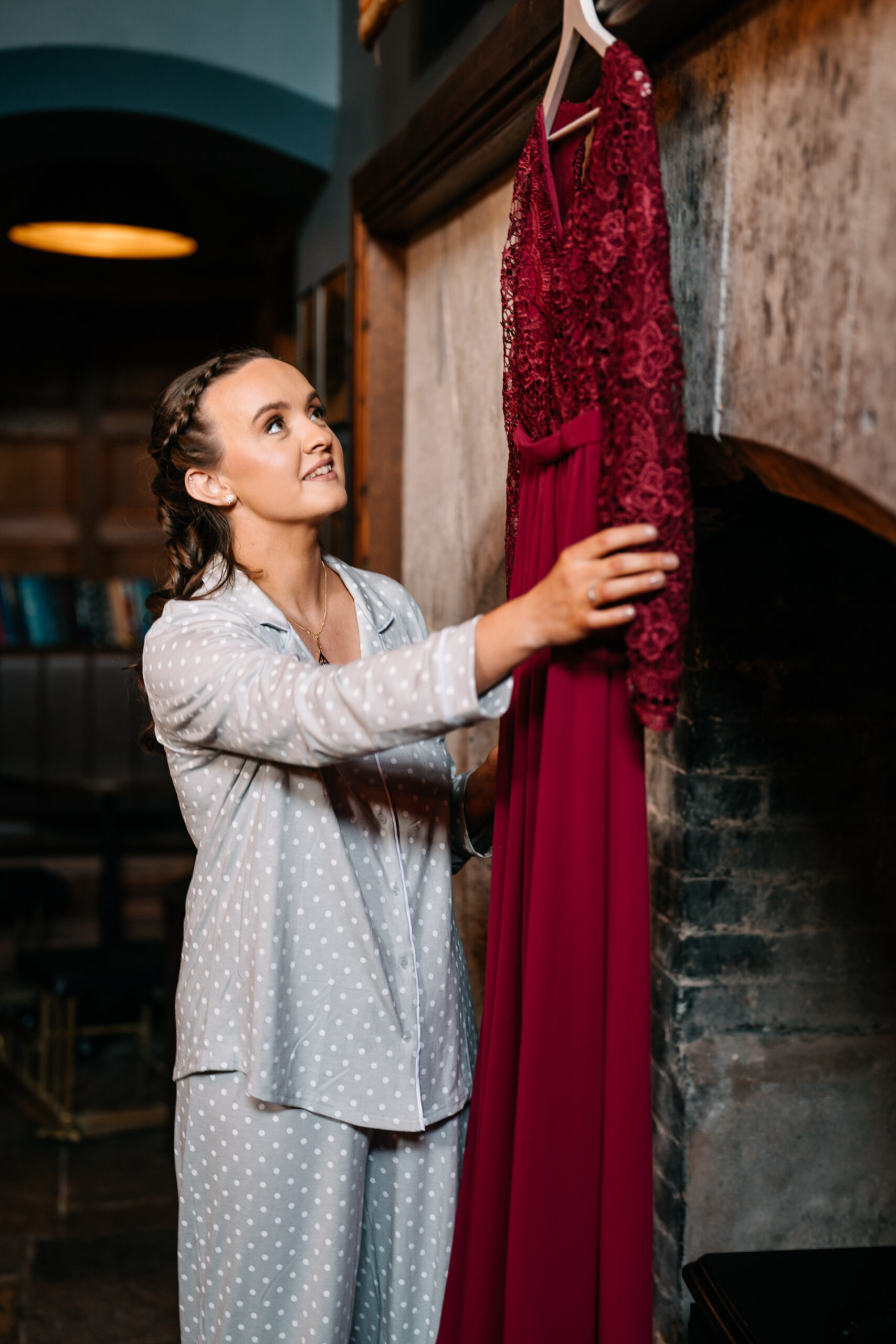 A person holding a red coat