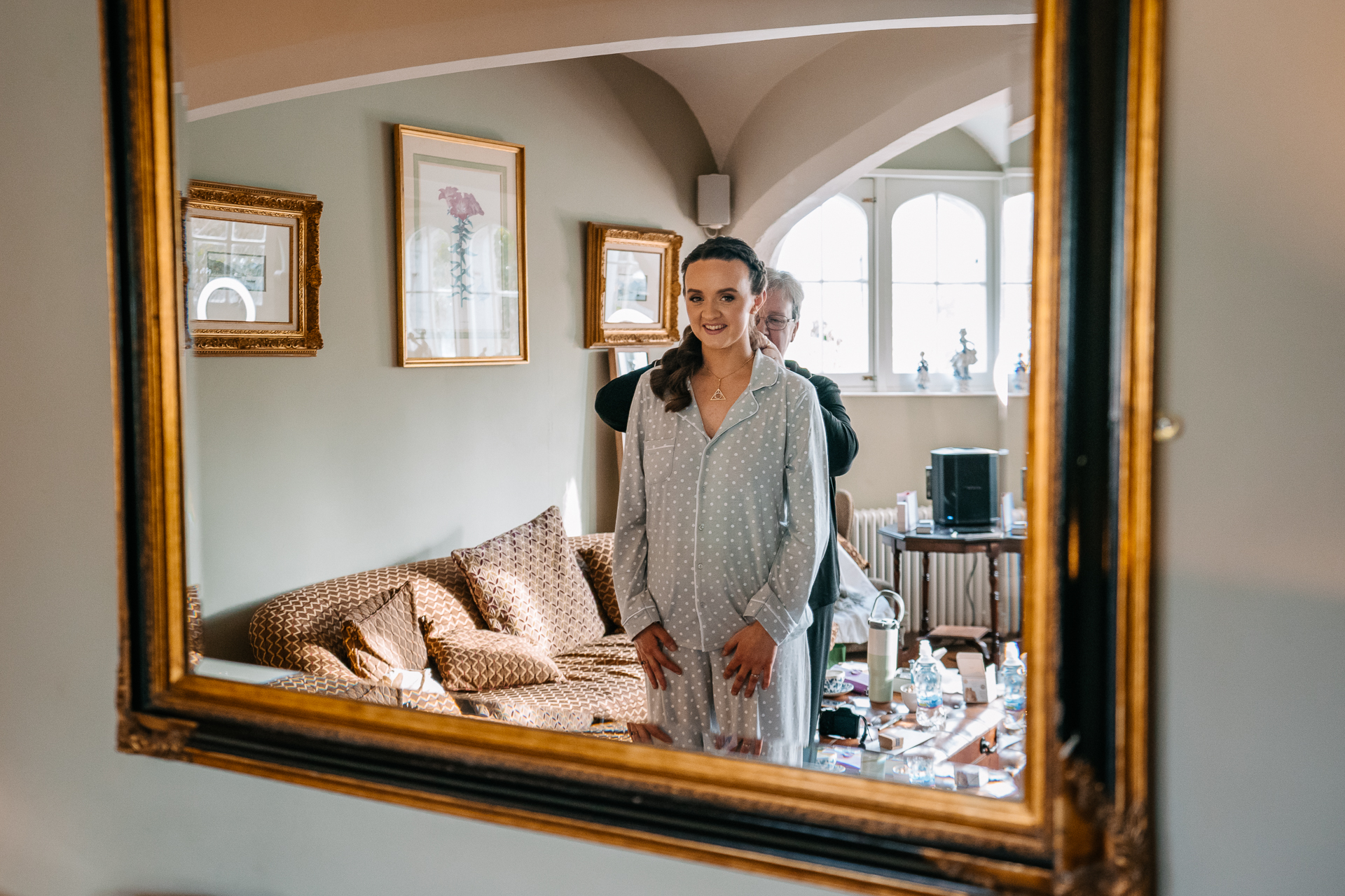 A man and woman standing in front of a mirror