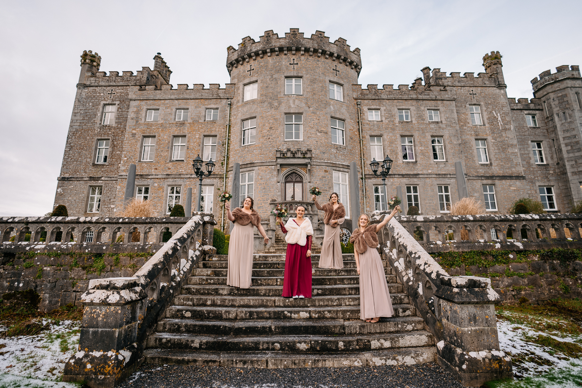 A group of people posing for a photo on some steps in front of a large building