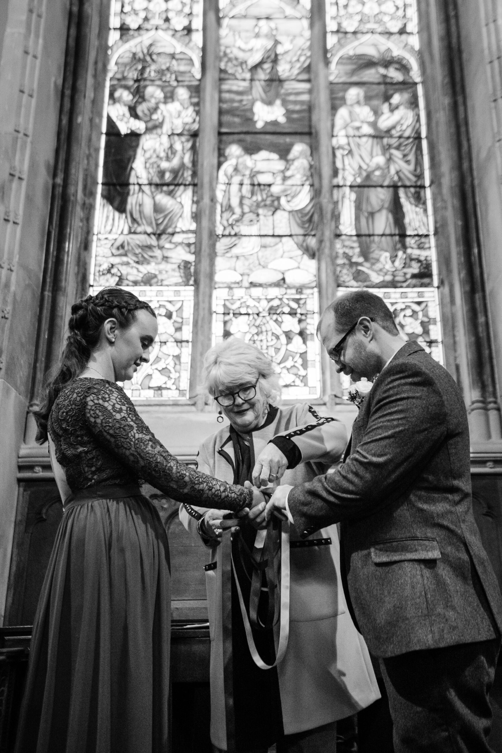 A man and woman cutting a man's hair