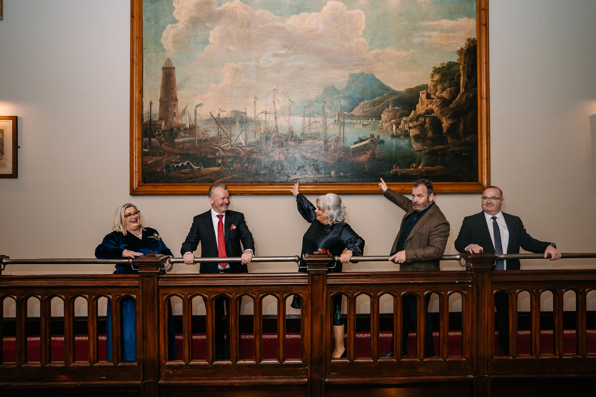 A group of people sitting at a table in front of a large map