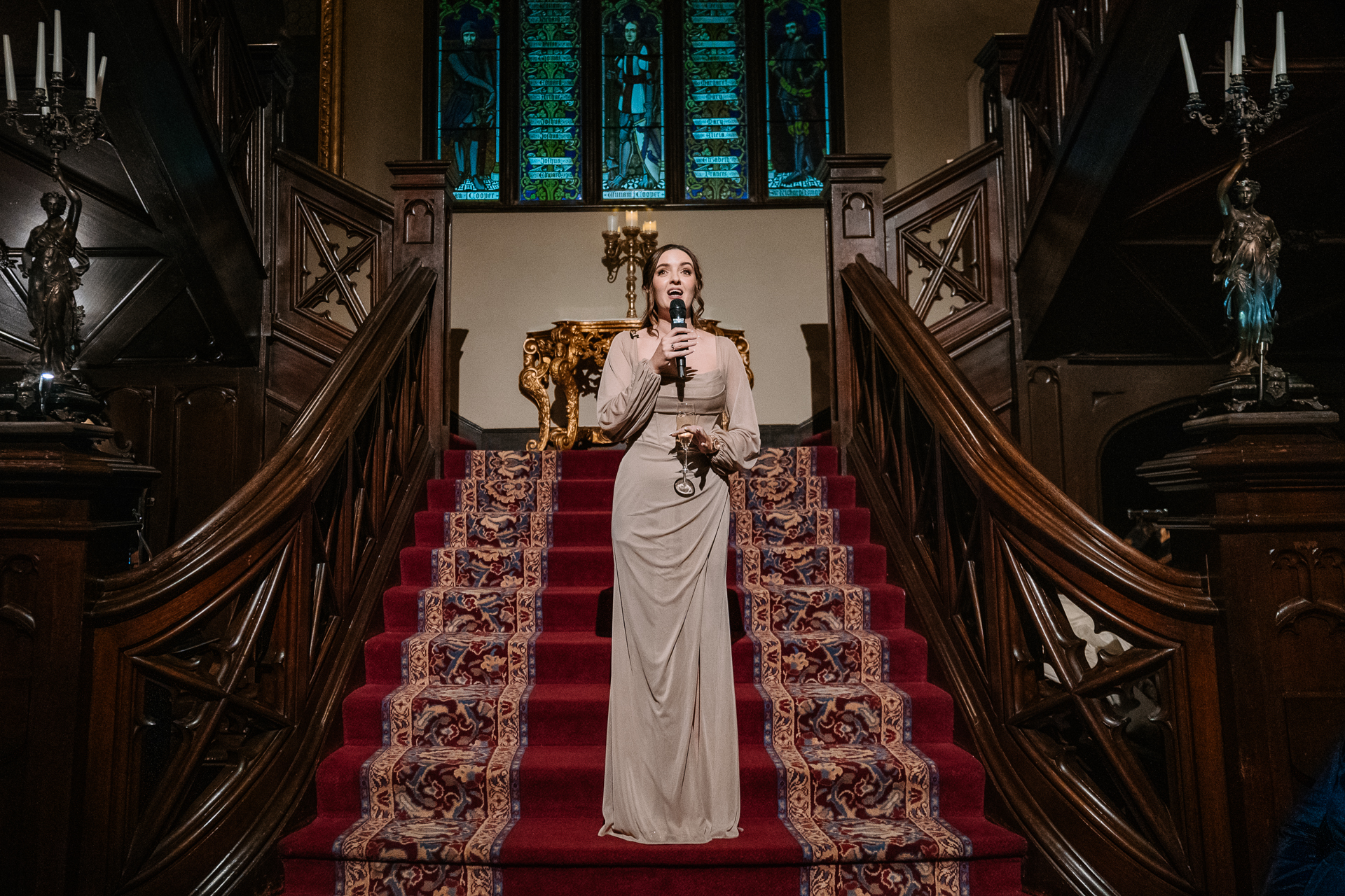 A person in a white dress standing on a staircase