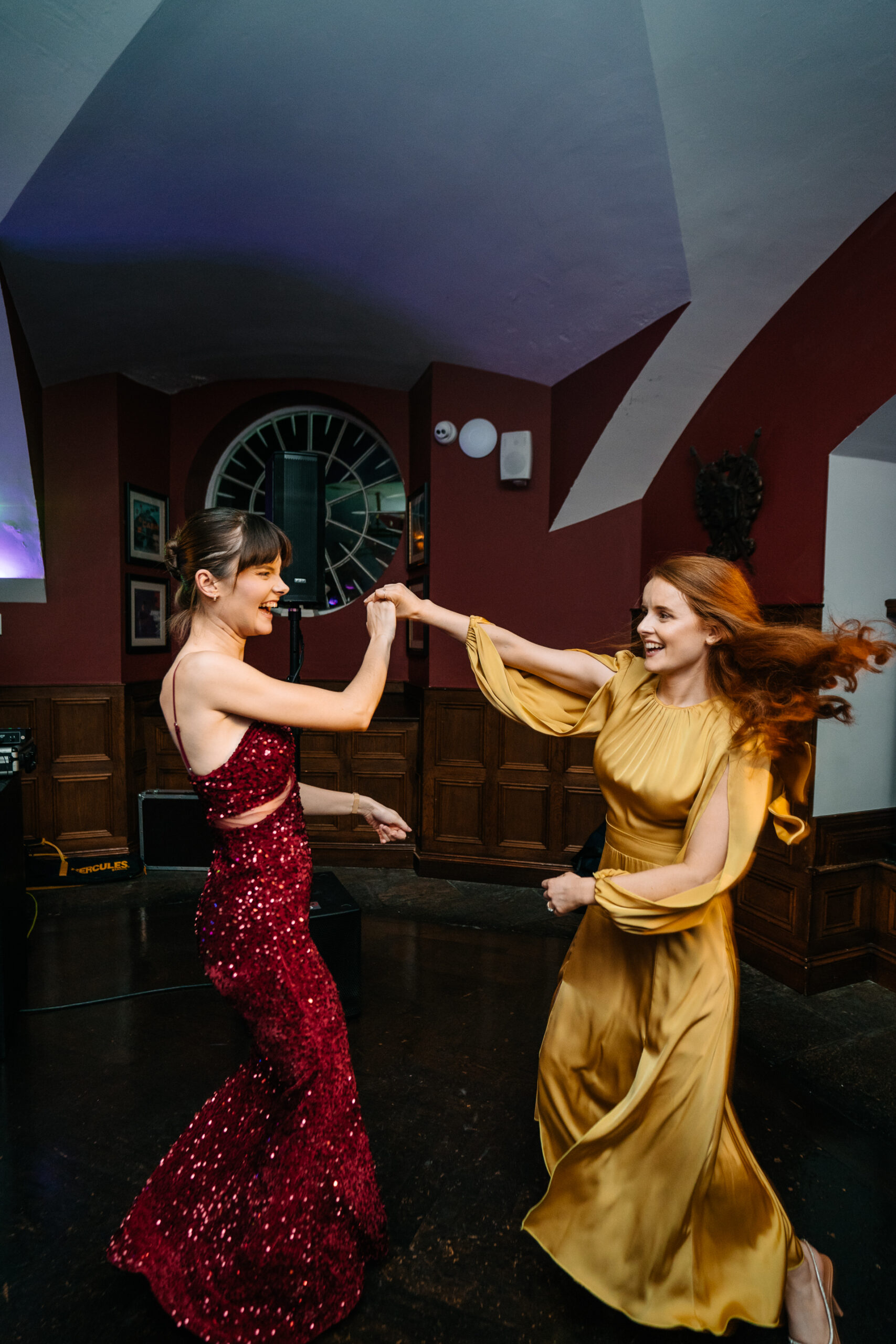 Two women in dresses dancing