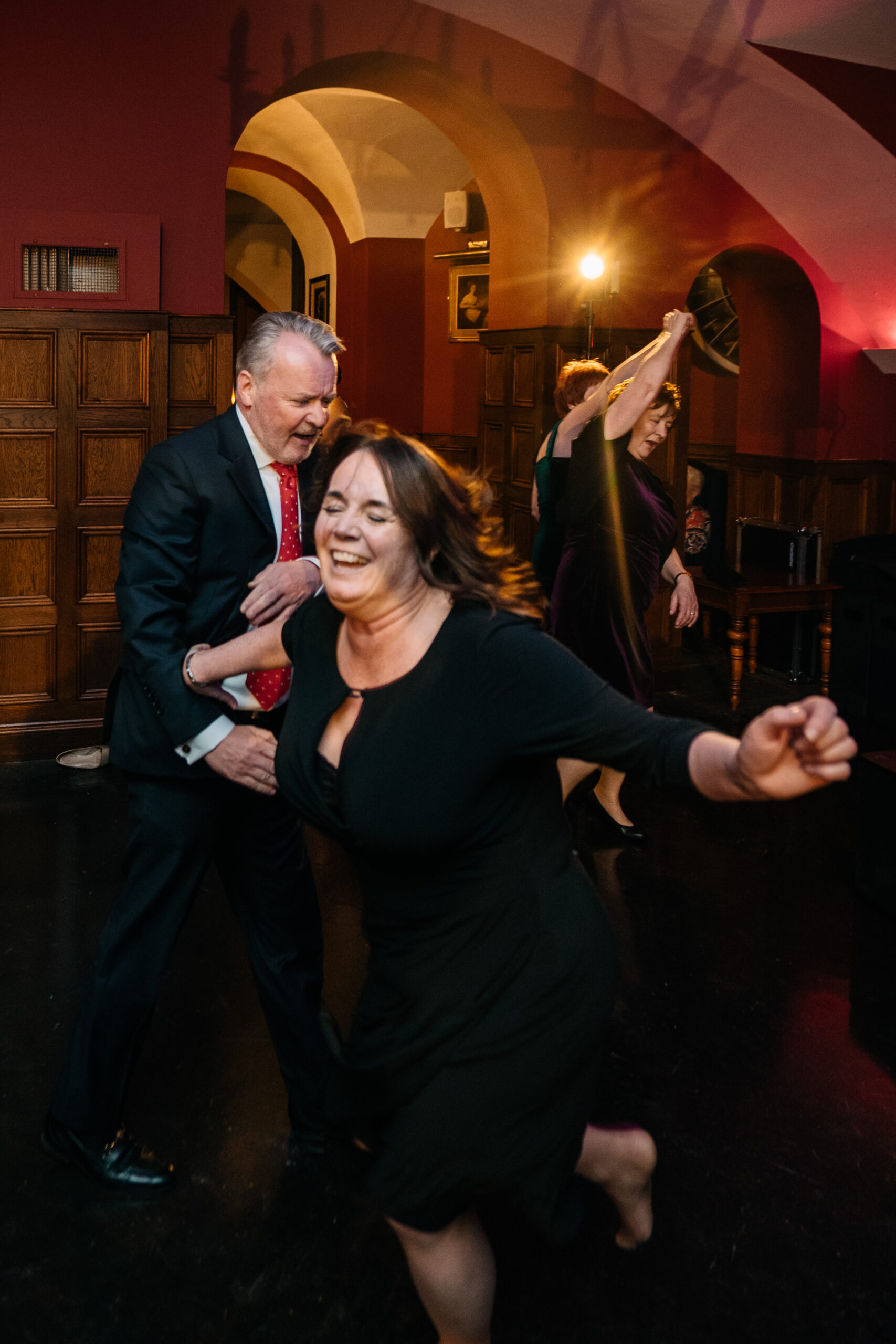 A woman dancing with a man in a suit and tie