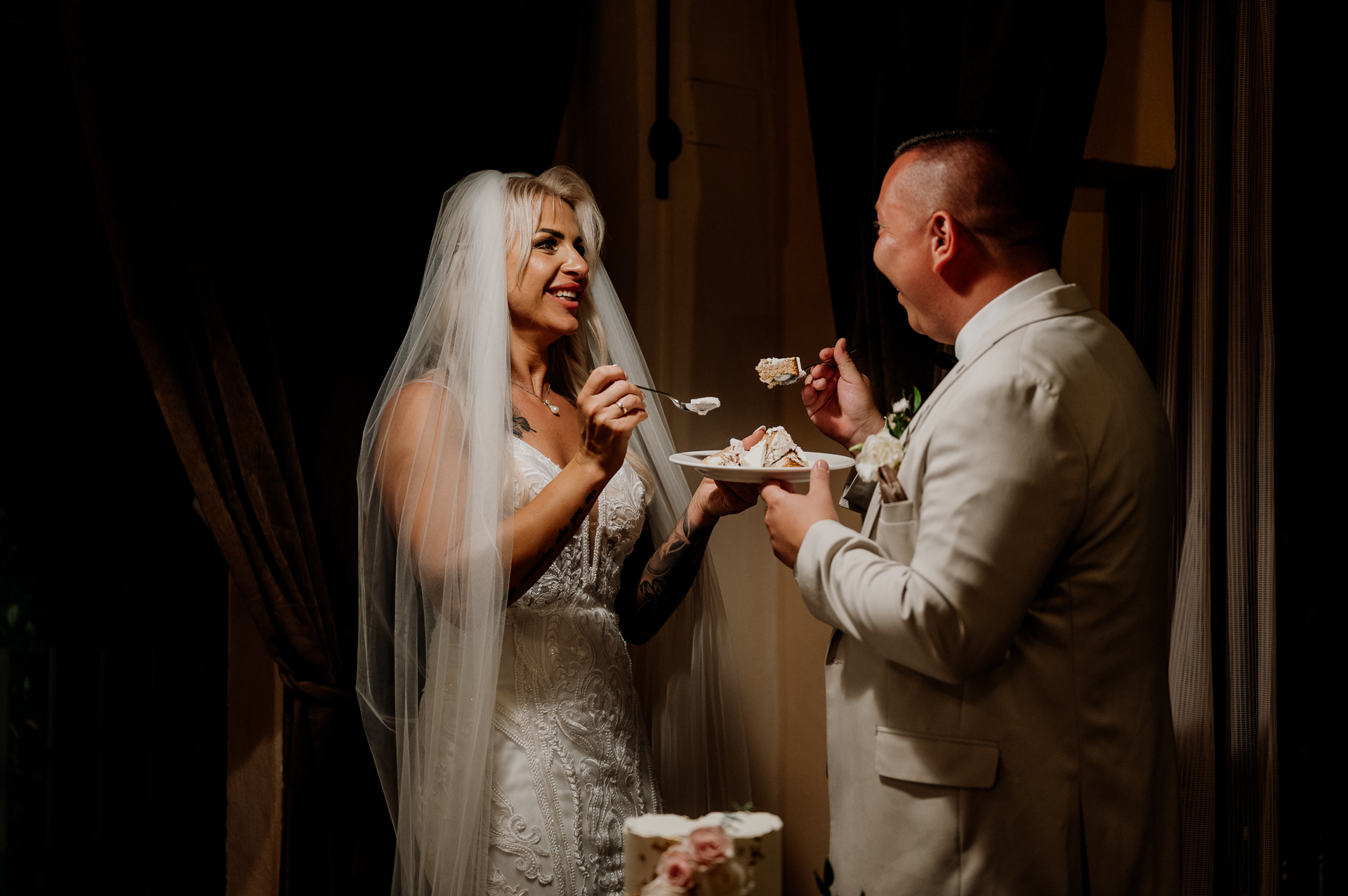 A bride and groom are eating cake