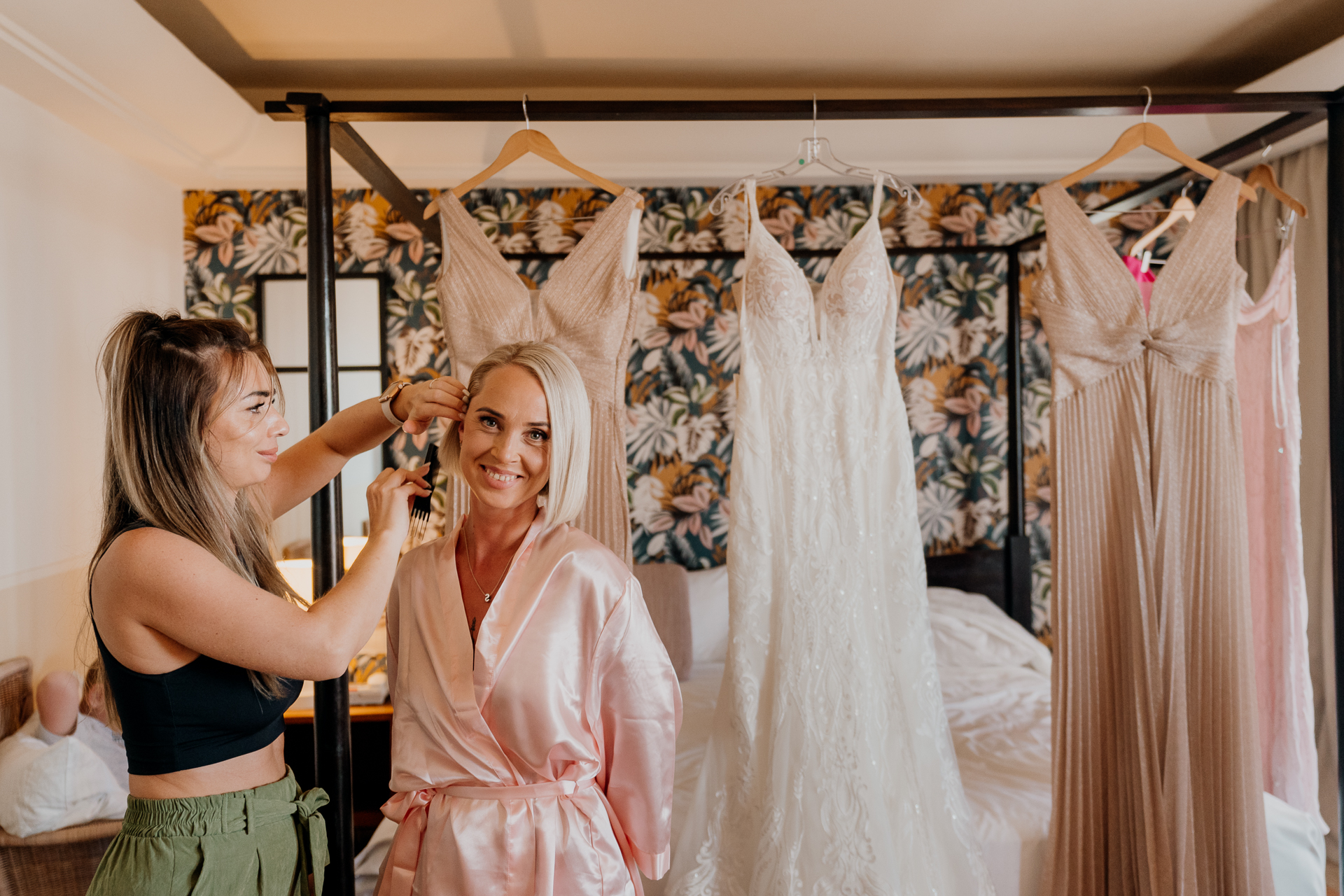 A person in a pink dress and a person in a white dress