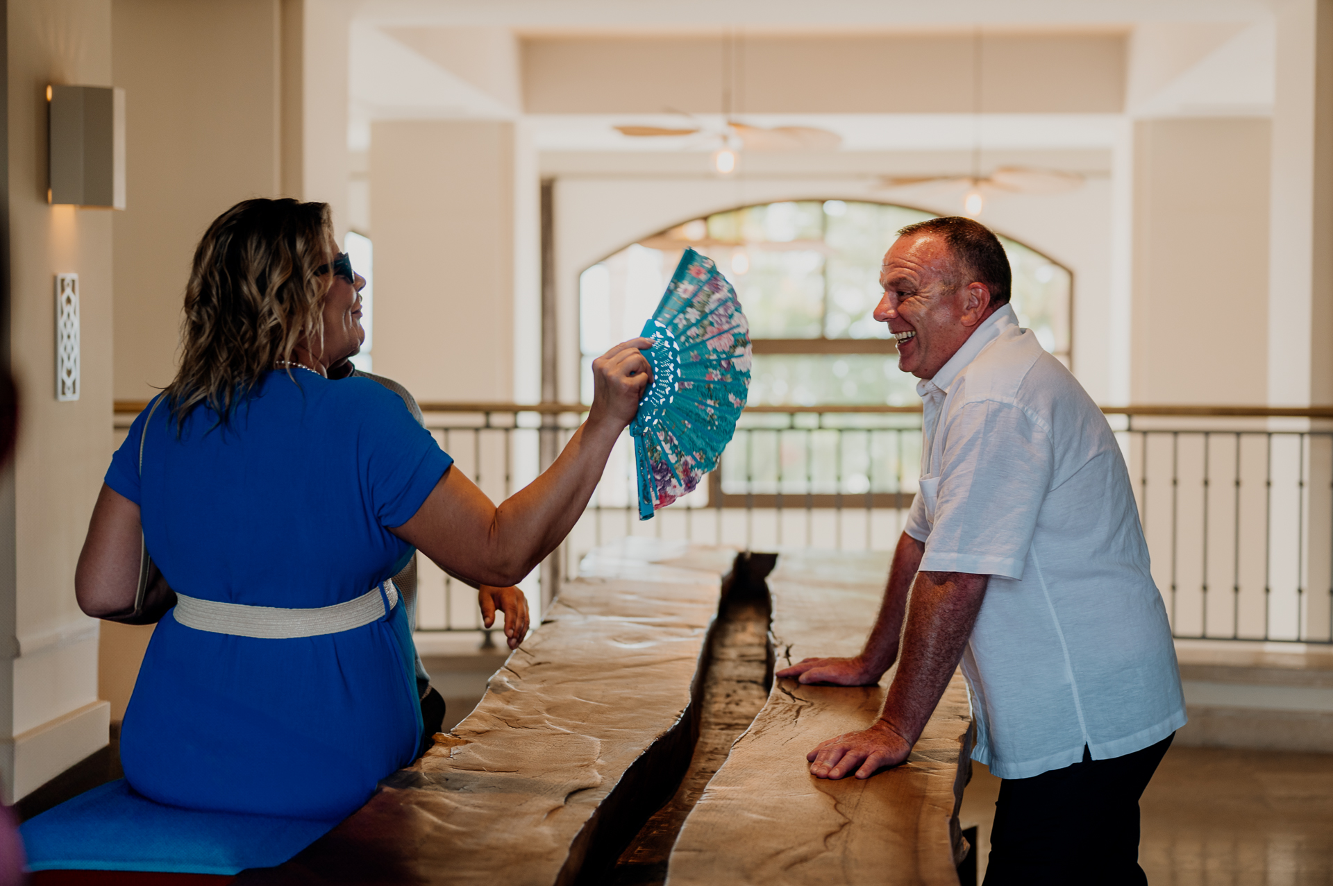 A man and woman holding a blue and white flag