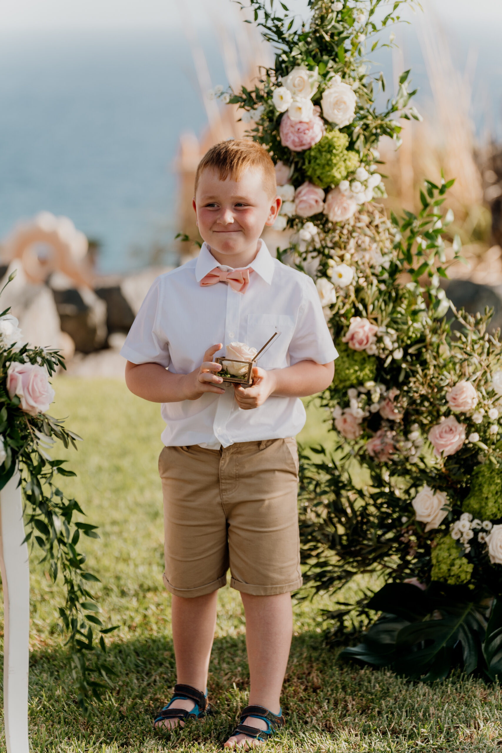 A boy holding a glass of wine