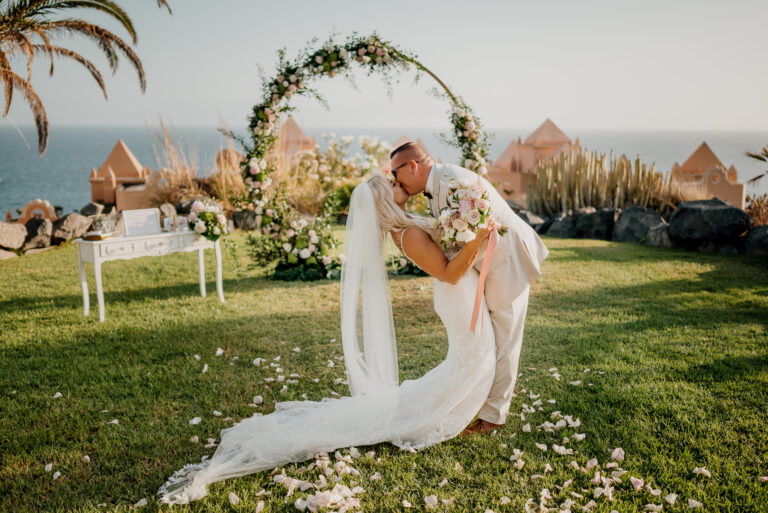 A person in a wedding dress sitting on a grass field