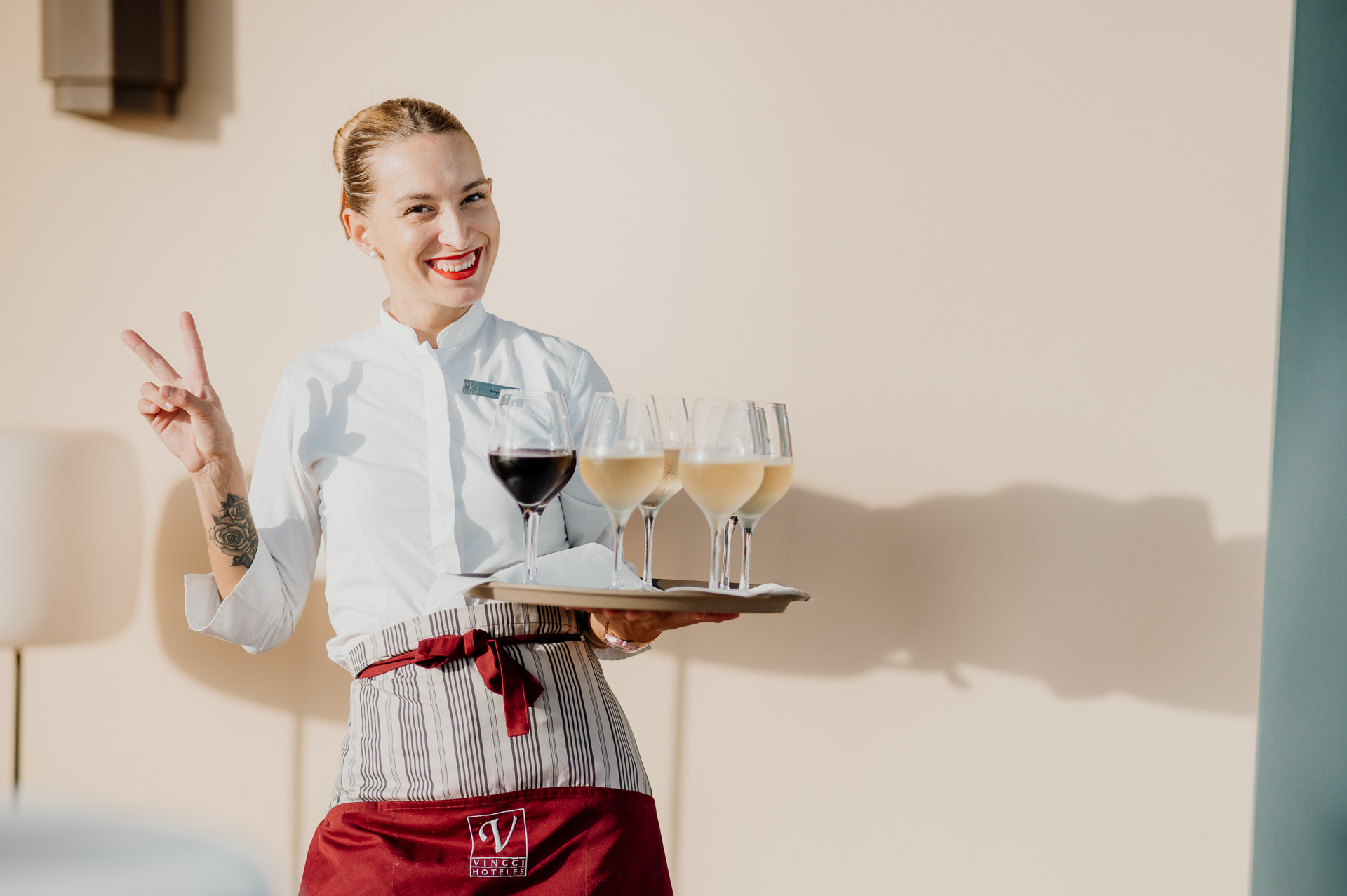 A person holding a plate of wine