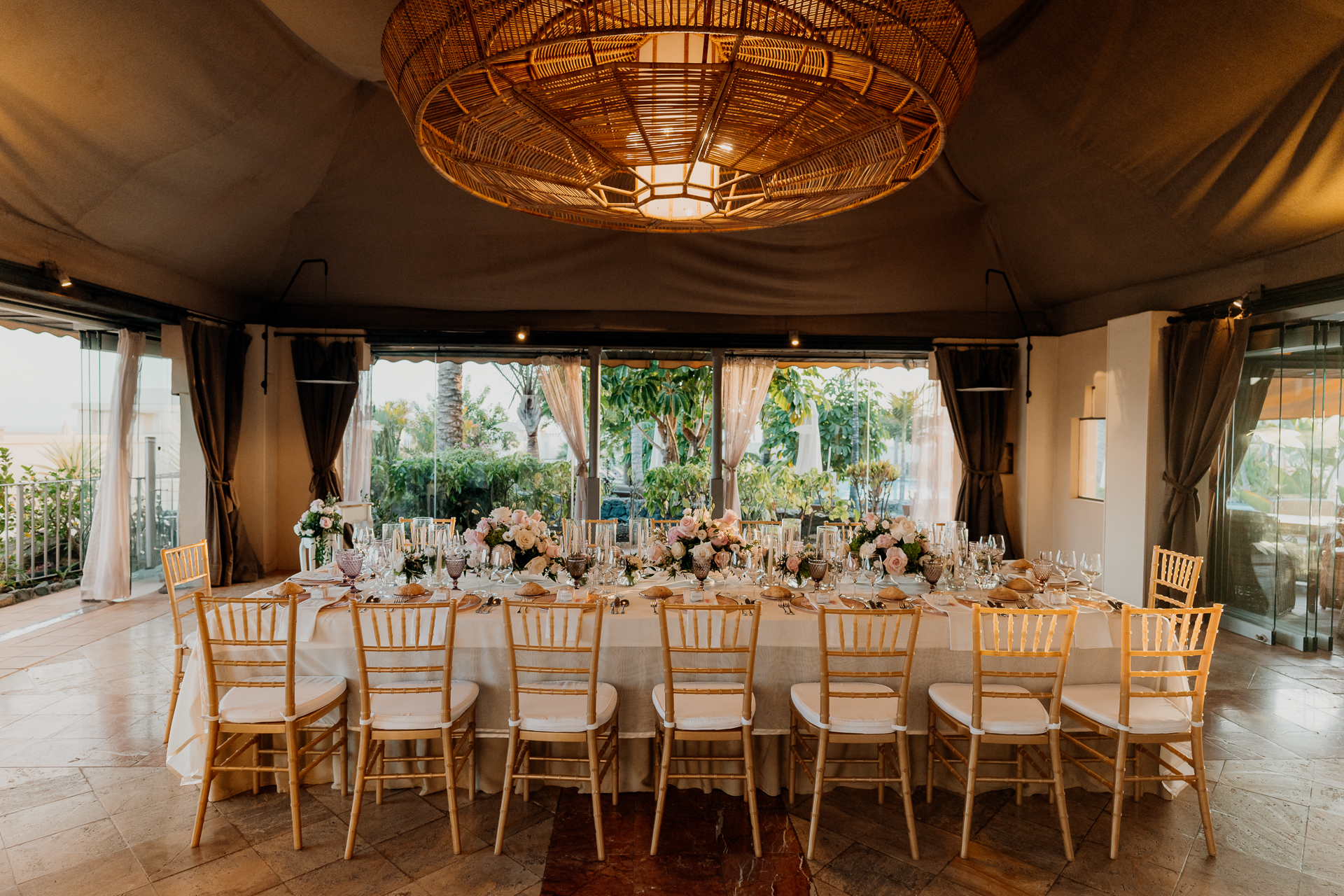 A dining room with a chandelier and chairs