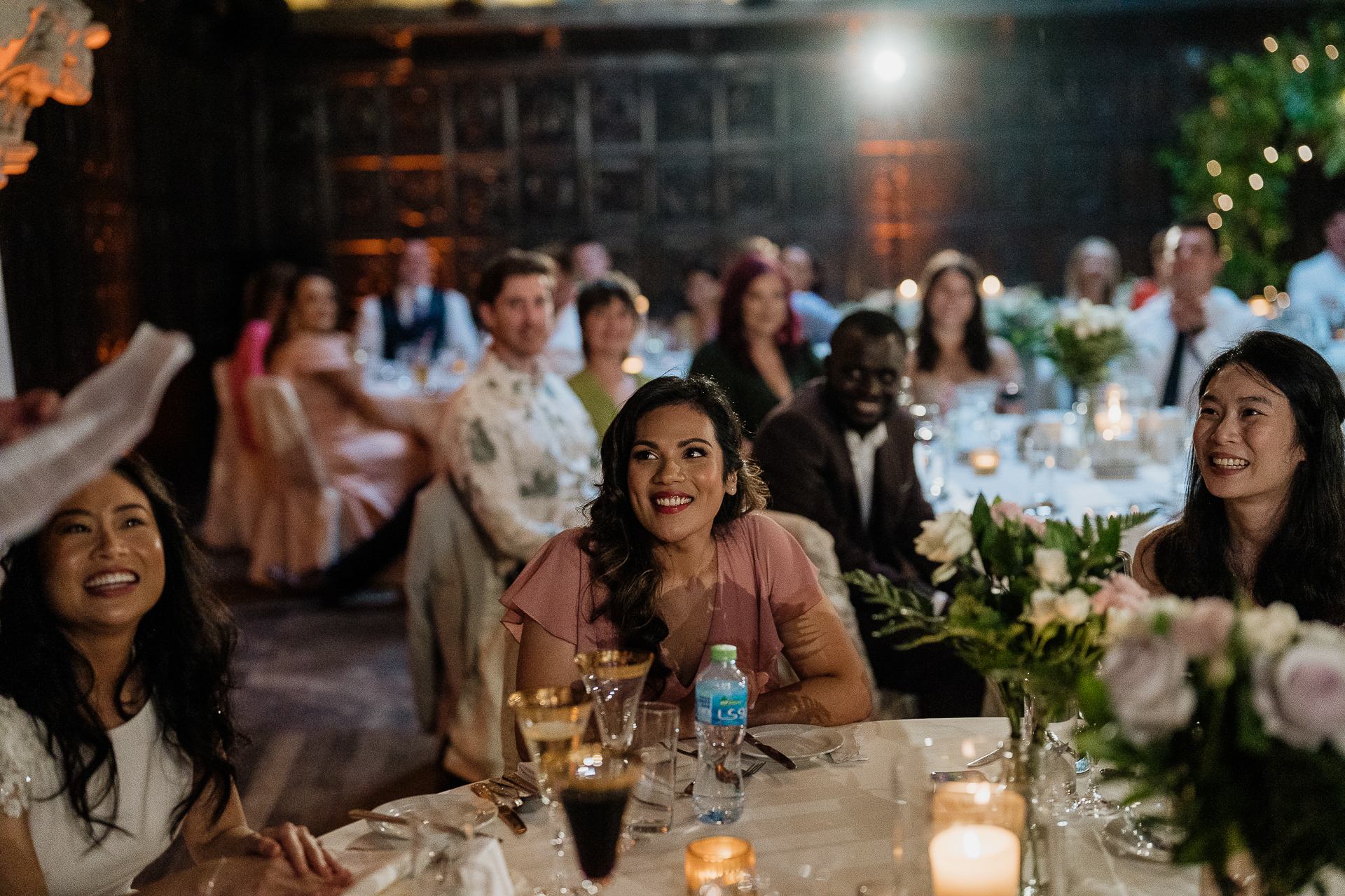 A group of people sitting at a table with flowers