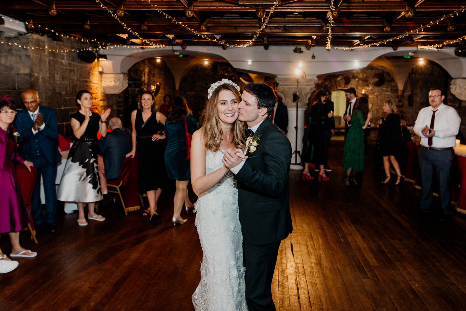 A man and woman dancing in a room full of people