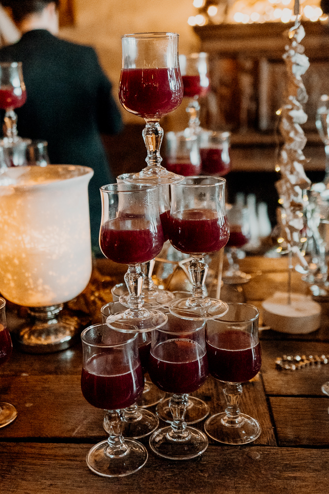 A group of glasses with red liquid