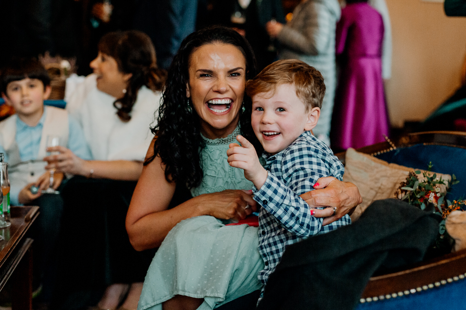 A person and a child sitting on a couch