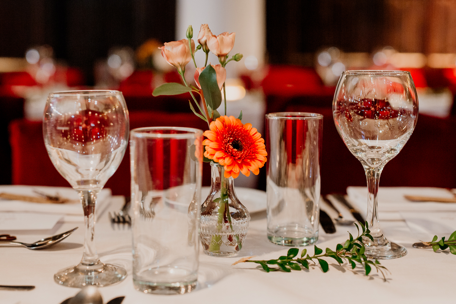 A table with glasses and flowers