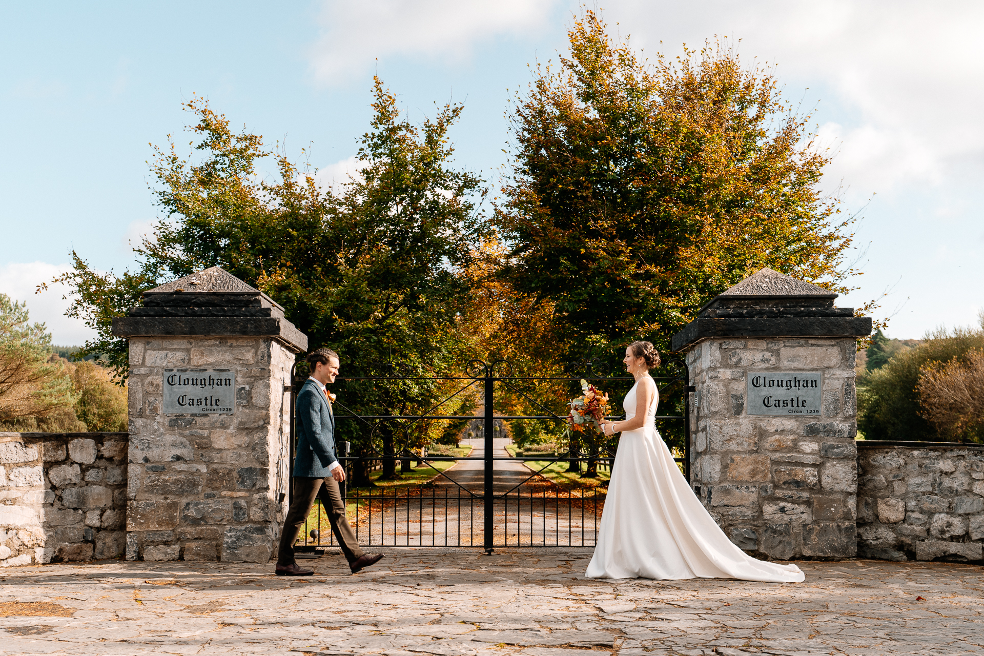 A man and woman walking down a path with a sign on it