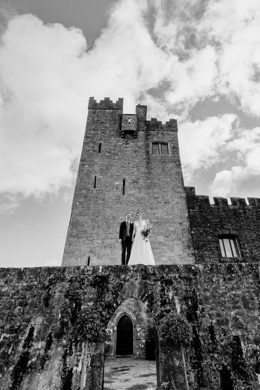 A couple standing on a stone building