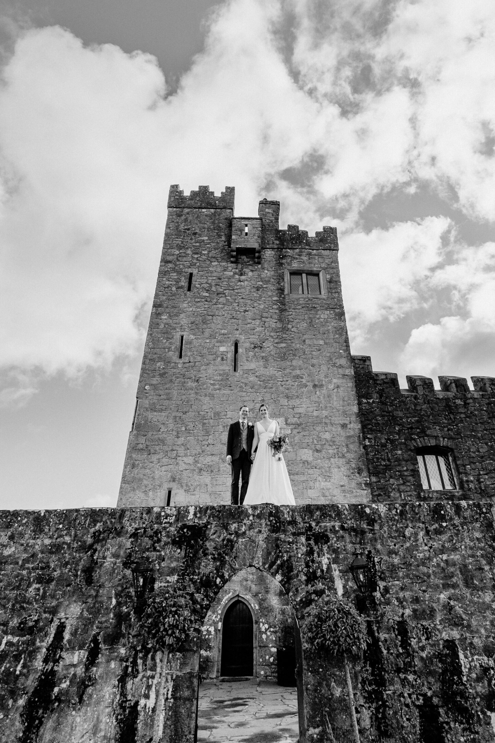 A couple standing on a stone building