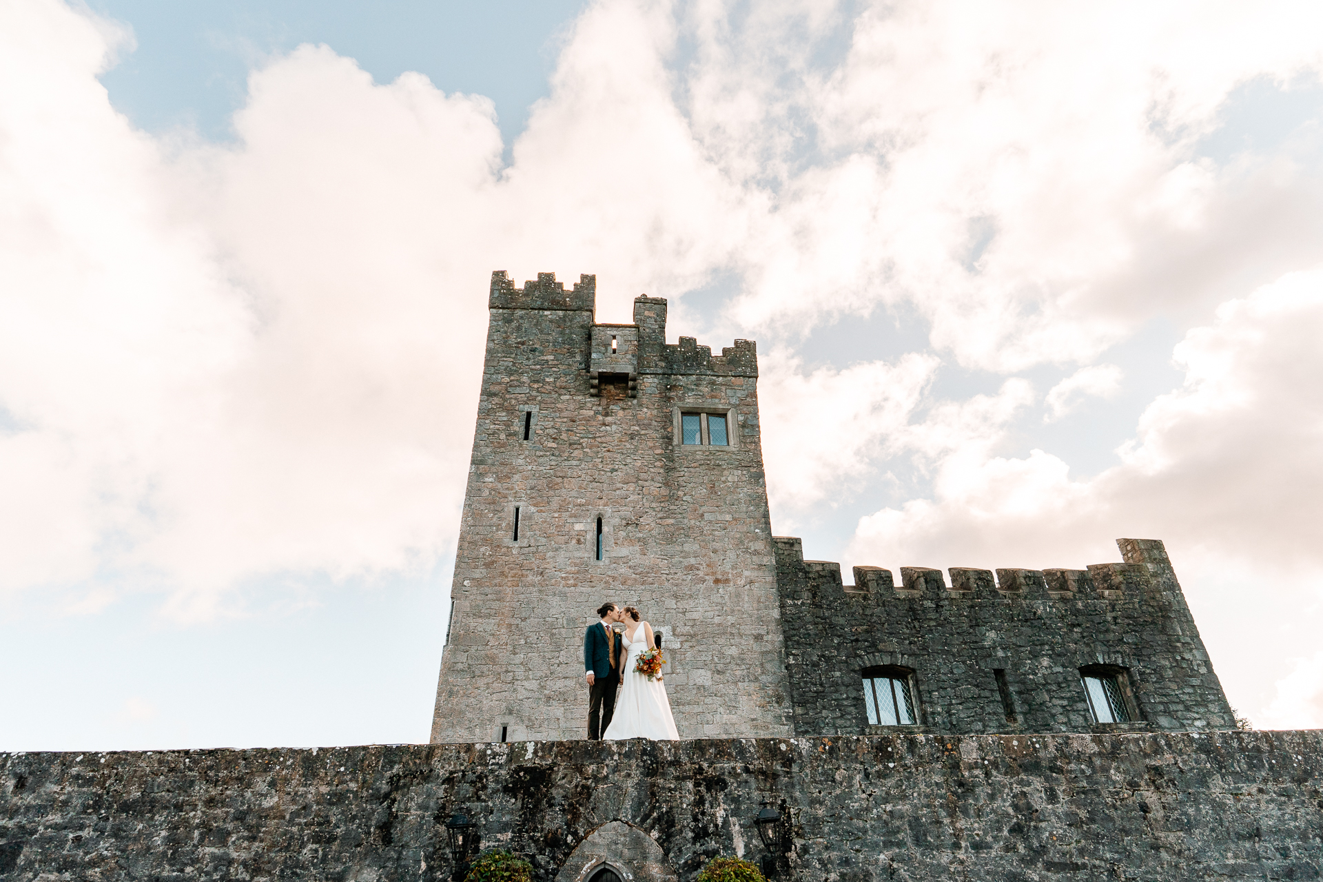 A couple standing in front of a castle