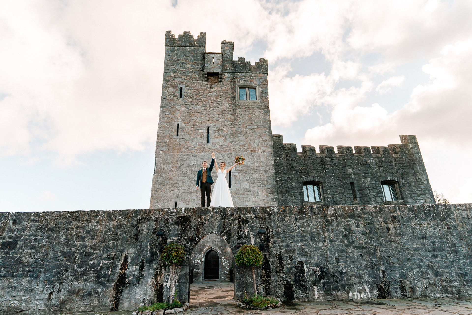 A couple standing on a stone wall