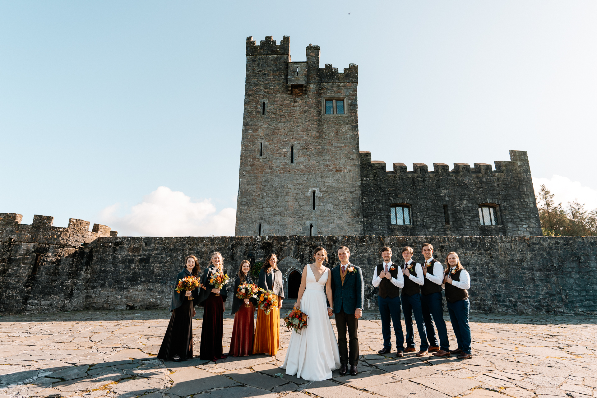 A group of people posing for a photo in front of a castle